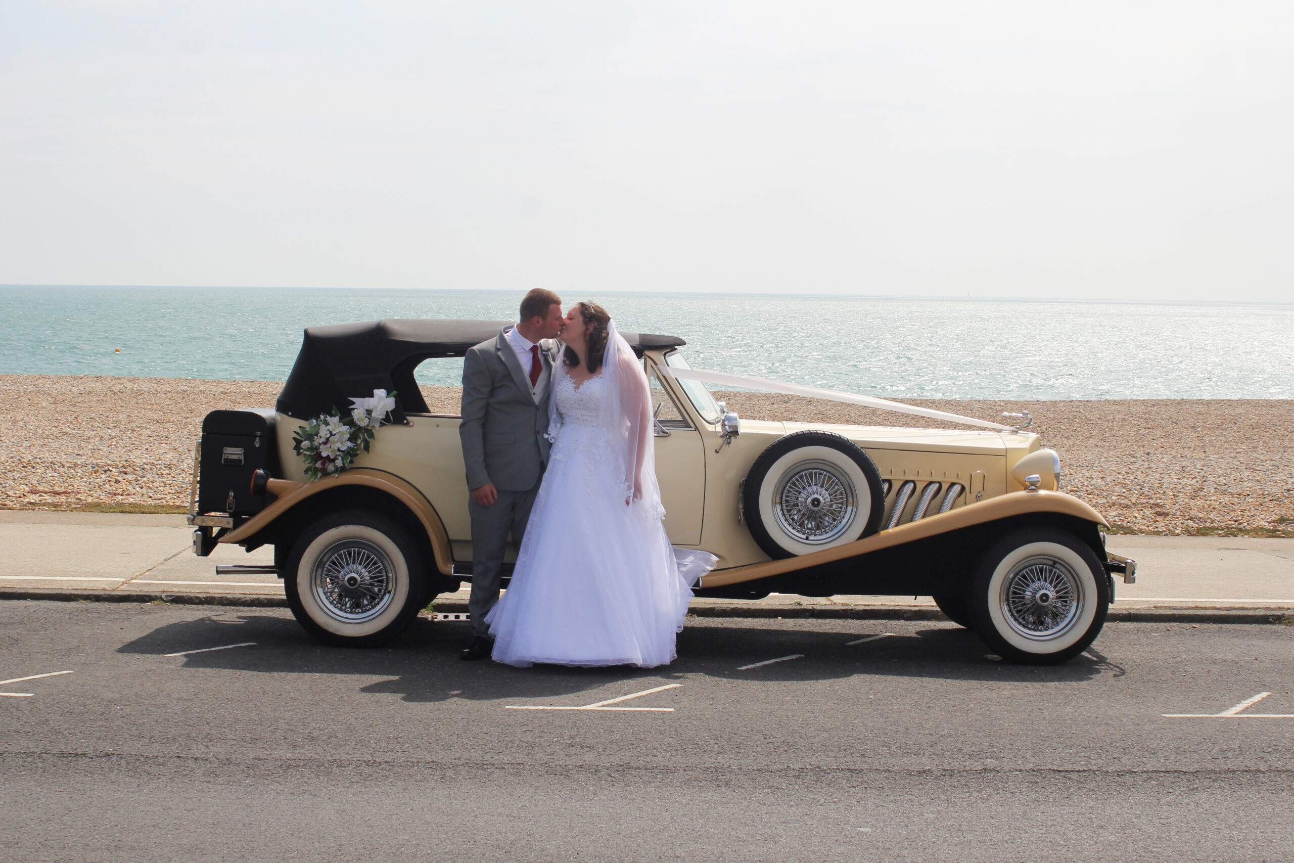 Beauford wedding car with couple, Seaford Seafront, East Sussex